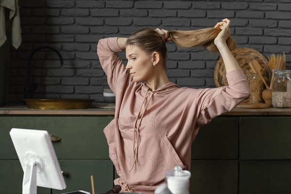 Medium shot woman tying her hair