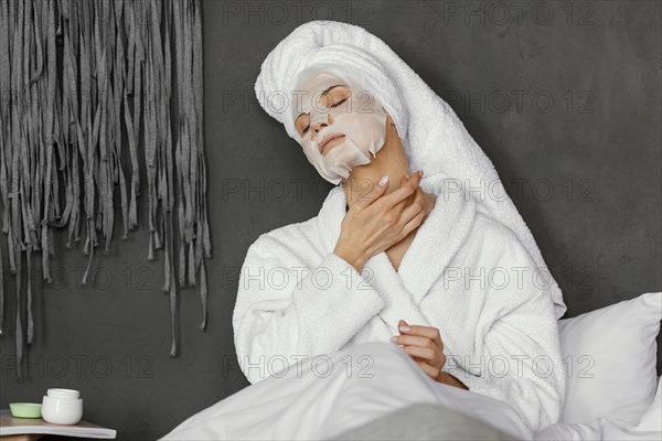 Medium shot woman with facial mask