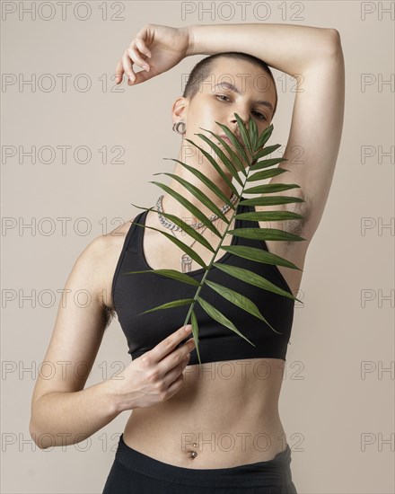 Medium shot woman with plant