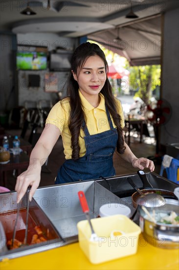 Medium shot woman working food truck