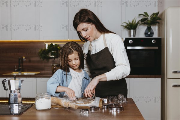 Mother daughter cooking together kitchen