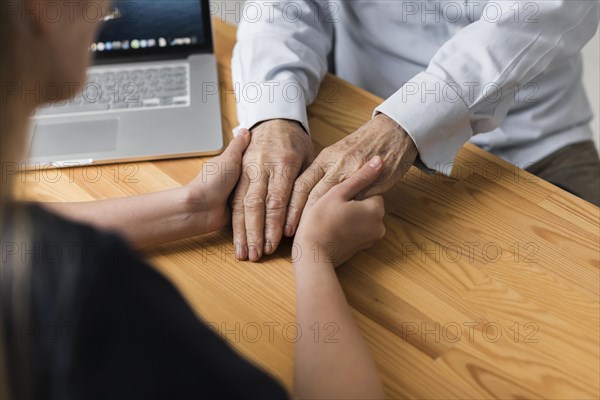 Nurse holding senior man s hands relief