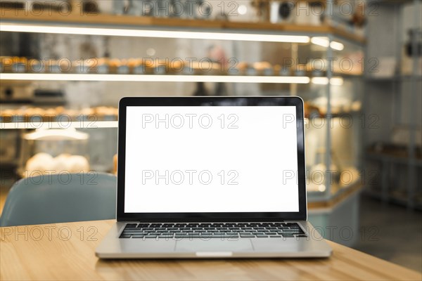 Open laptop with blank white screen display table coffee shop