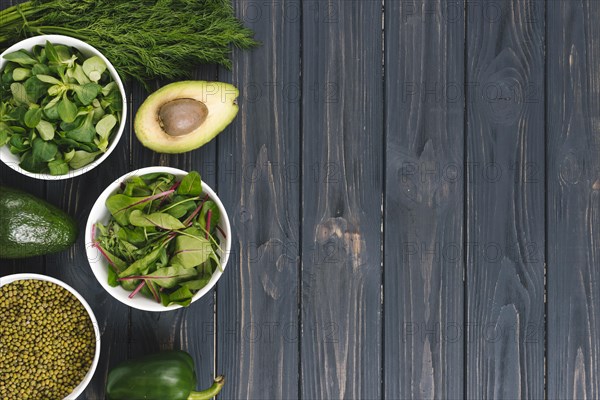 Overhead view green vegetables black wooden desk