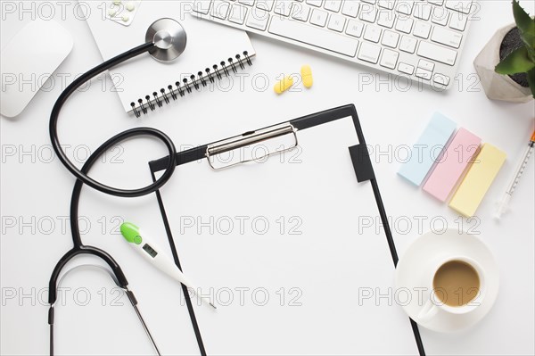 Overhead view medical desk with coffee cup adhesive notes table