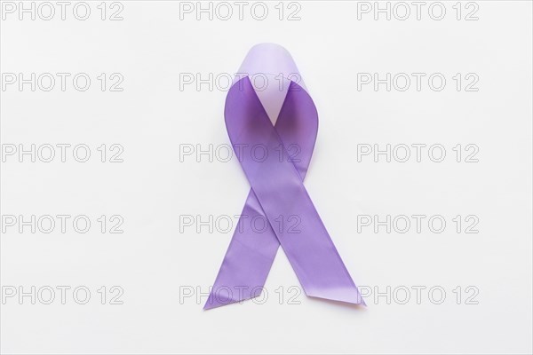 Overhead view purple awareness ribbon white background