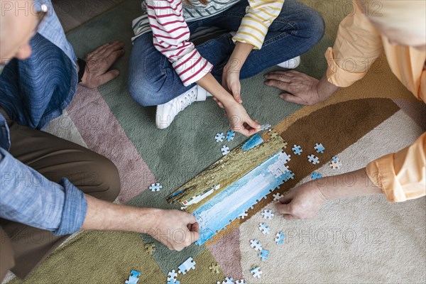 People doing puzzle floor close up