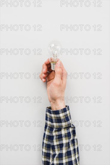 Person holding simple light bulb