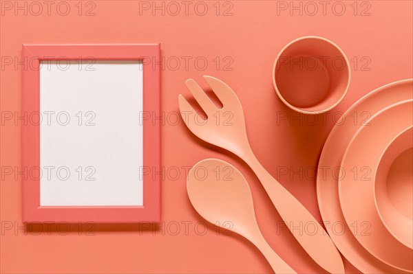 Pink composition with empty frame plastic dishes