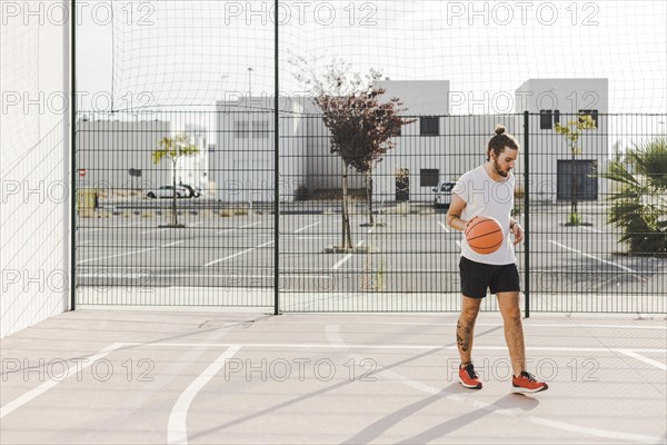 Portrait baskeball player standing court