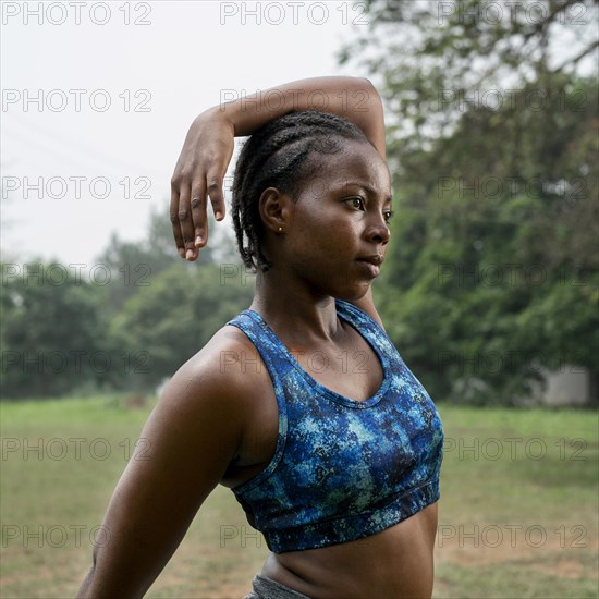 Portrait sporty woman nature stretching