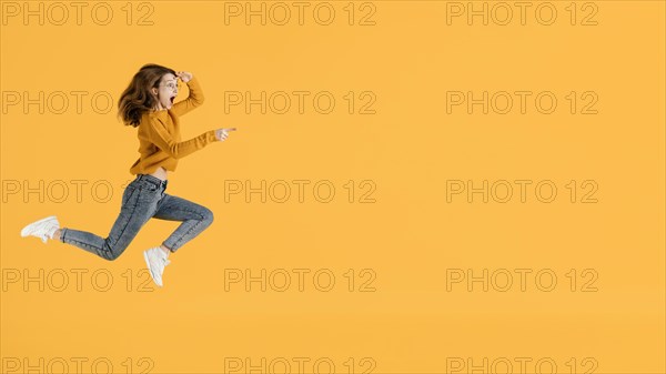 Portrait young female jumping with copy space