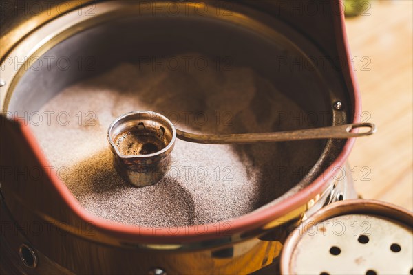 Preparation turkish coffee cezve sand cafe bar