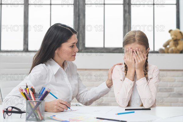 Psychologist supporting girl suffering from depression