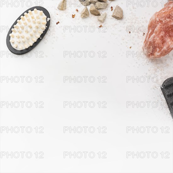 Salt massage brush pumice stone himalayan pink rock salt isolated white backdrop