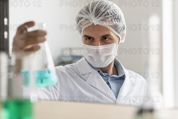 Scientist holding flask close up