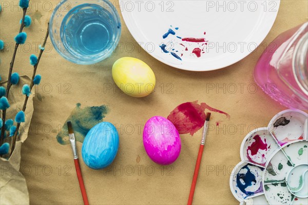 Set easter eggs near willow twigs brushes