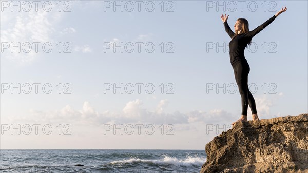 Side view woman enjoying view coast with copy space