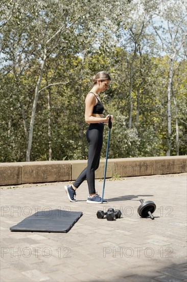 Side view woman with training equipment outdoors