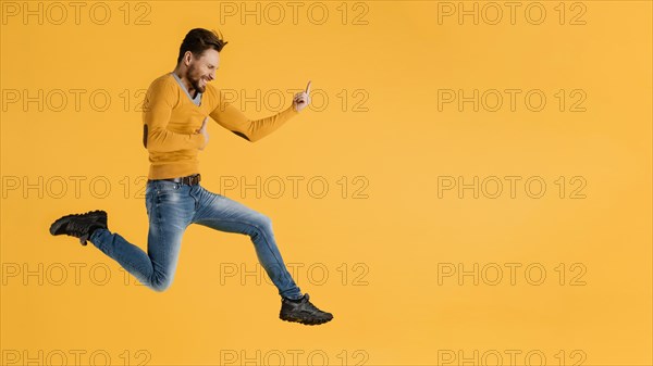 Side view young man jumping