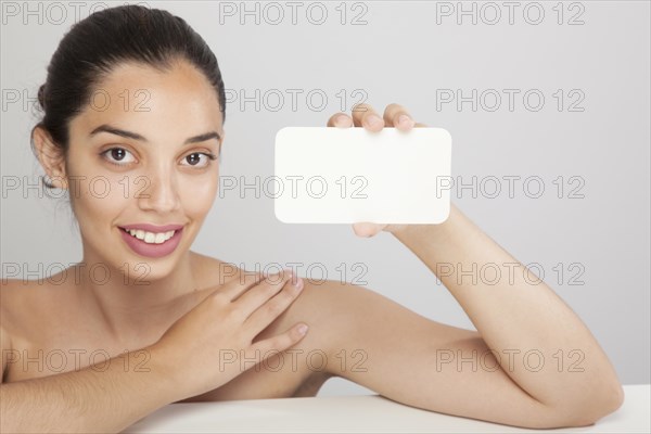 Smiley woman holding card