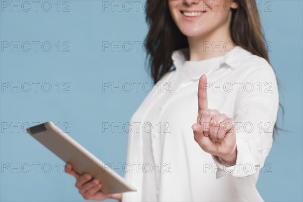 Smiley woman holding digital tablet
