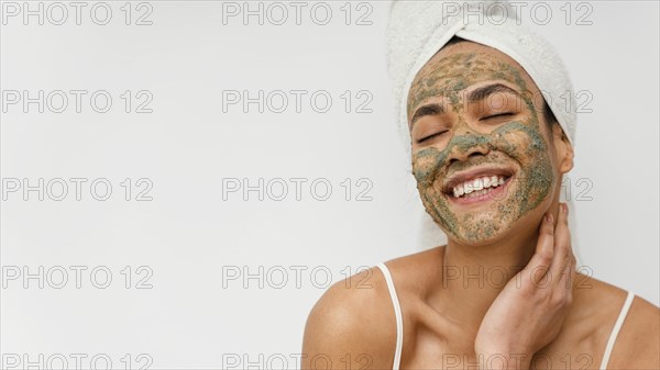 Smiley woman with natural face mask copy space