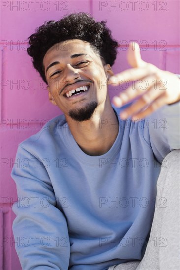 Smiley young man outdoor sitting