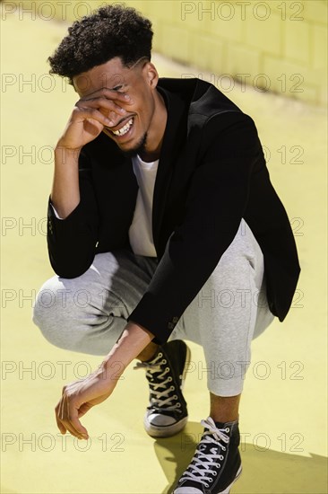 Smiley young man outdoor sitting 2