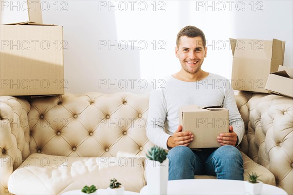 Smiling man with cardboard box