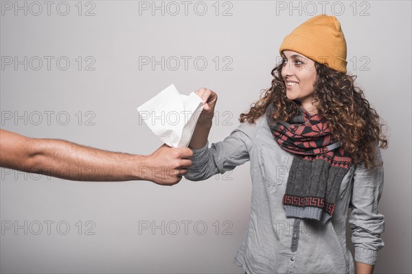 Smiling sick woman taking tissue paper from man s hand