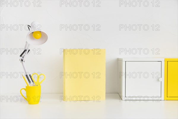 Spacious workplace with metal boxes yellow notebook