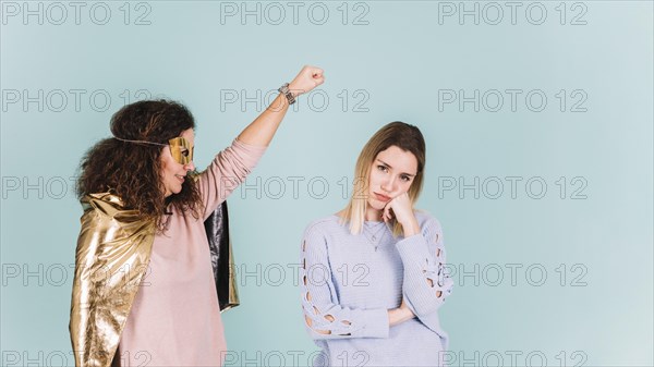 Superhero mother near bored daughter