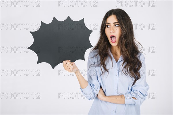 Surprised woman presenting speech bubble slate