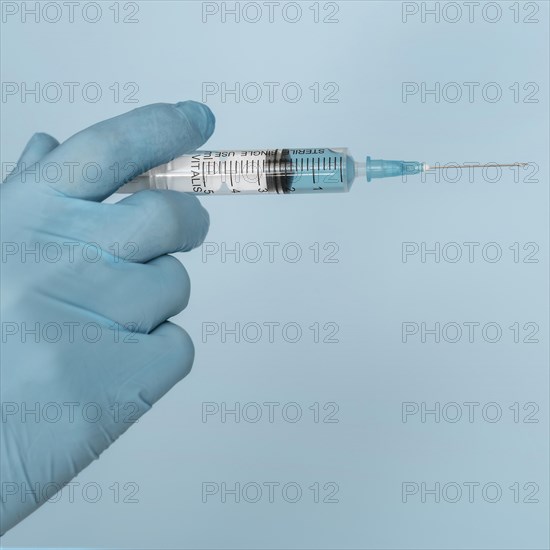 Syringe hands wearing glove