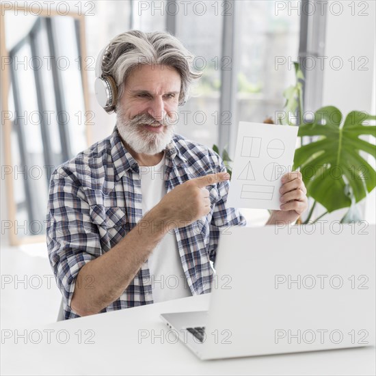 Teacher showing geometry shapes laptop