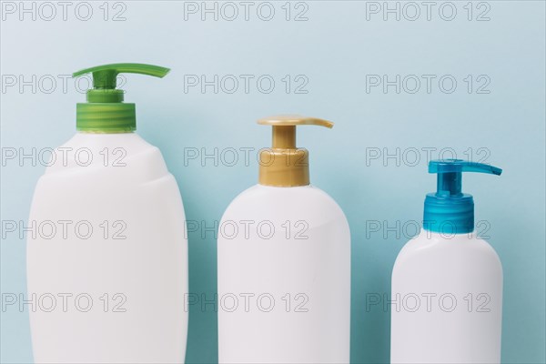 Three bottles with bright pumps