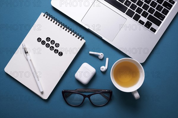 Top view desk with laptop notebook tea