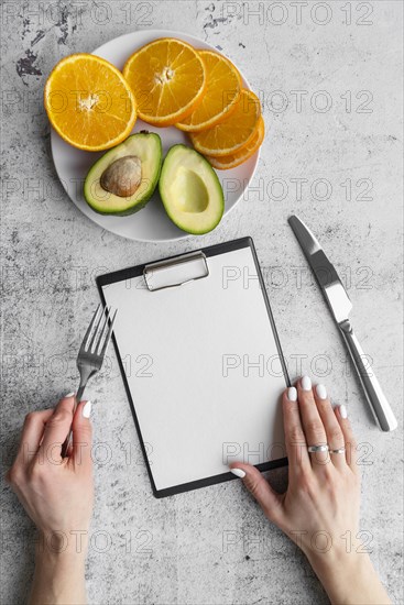 Top view empty menu with avocado orange slices