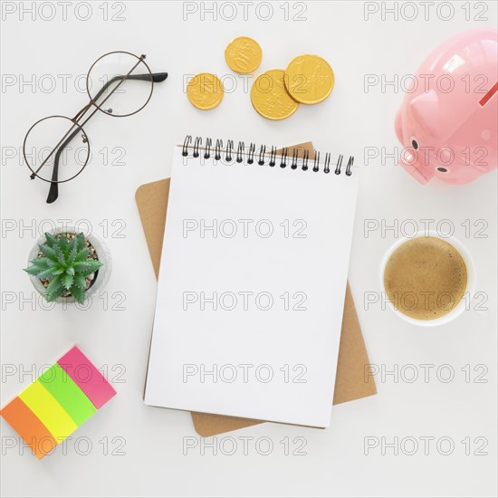 Top view financial elements arrangement with empty notepad