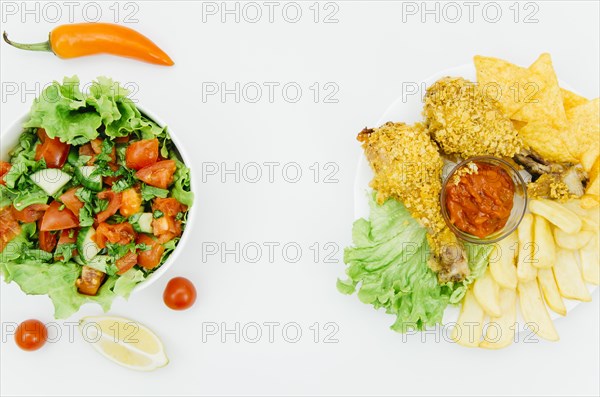 Top view fried chicken vs salad