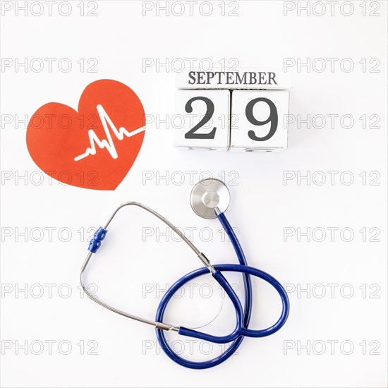 Top view paper heart with date stethoscope