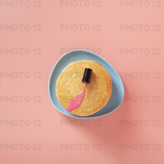 Top view pink nail polish pancakes with plain background