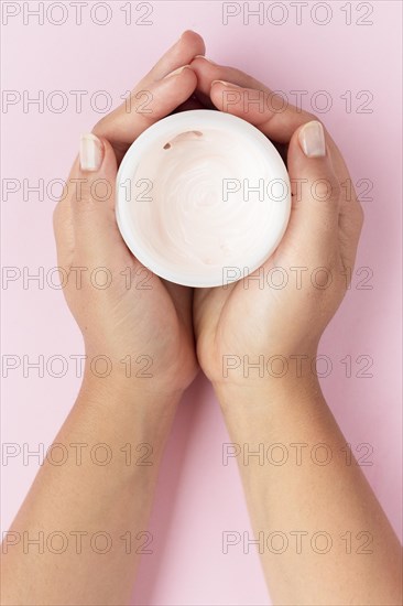 Top view woman holding face cream box