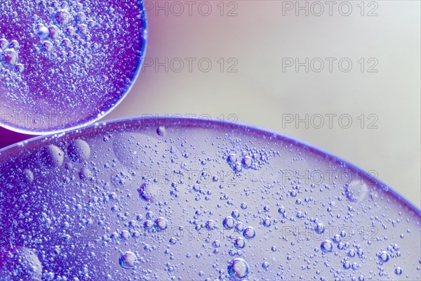 Translucent oil drops water blurred background