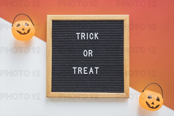 Trick treat baskets near frame with writing