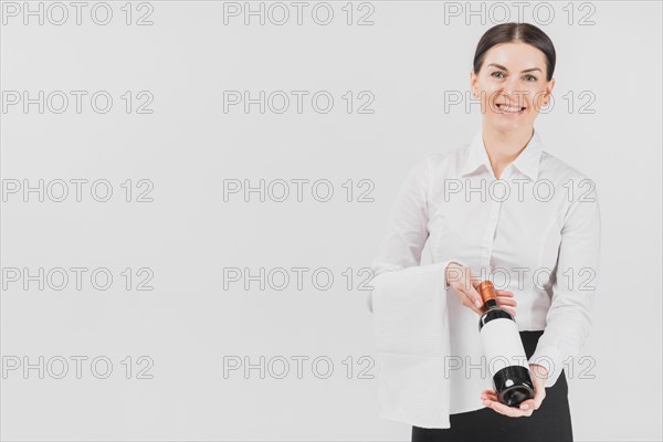 Waitress woman offering bottle wine