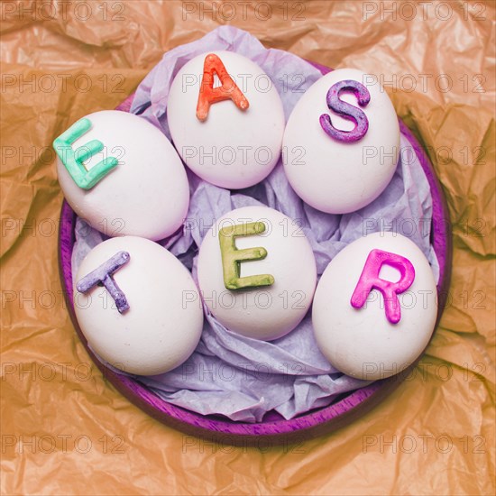 White eggs decorated by letters tray