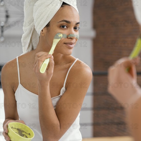 Woman applying homemade mask her face