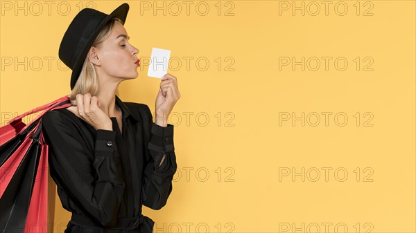 Woman black friday sale kissing gesture copy space